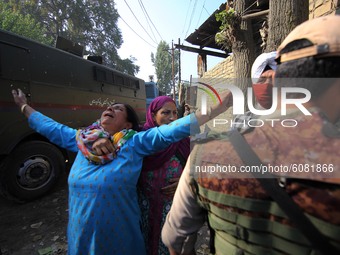 A civilian woman wails near the gun-fight site in Barzulla area of Srinagar, Kashmir on October 12, 2020.Clashes erupted between angry prote...