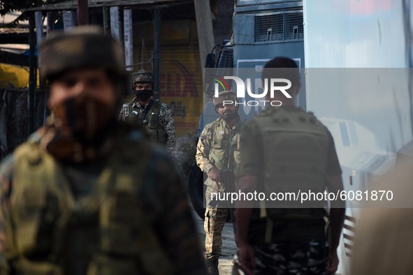 Indian policemen walk seen near the gun-battle site in Barzulla area of Srinagar, Kashmir on October 12, 2020.Clashes erupted between angry...