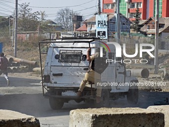A police vehicle chasing a protestor in Barzulla area of Srinagar, Kashmir on October 12, 2020.Clashes erupted between angry protestors and...