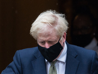 British Prime Minister Boris Johnson leaves 10 Downing Street for the House of Commons to deliver a statement setting out significant new re...