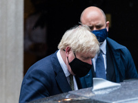 British Prime Minister Boris Johnson leaves 10 Downing Street for the House of Commons to deliver a statement setting out significant new re...