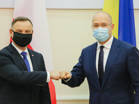 Prime Minister of Ukraine Denys Shmyhal (R) and President of Poland Andrzej Duda pose for a photo during the meetng in Kyiv, Ukraine, Octobe...