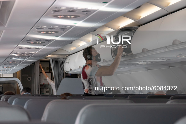 A male passenger during the flight as seen with the mandatory facemask. Flying with Lauda Airbus A320 airplane with registration 9H-LMJ duri...