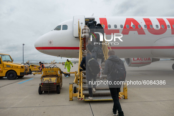 Passengers boarding in the plane for the flight in Vienna. Flying with Lauda Airbus A320 airplane with registration 9H-LMJ during the Covid-...