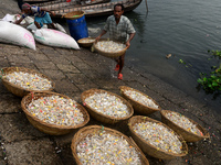 Worker washes recycled plastic chips in the river Buriganga in Dhaka, Bangladesh on October 13, 2020. Buriganga river, which flows by Dhaka...