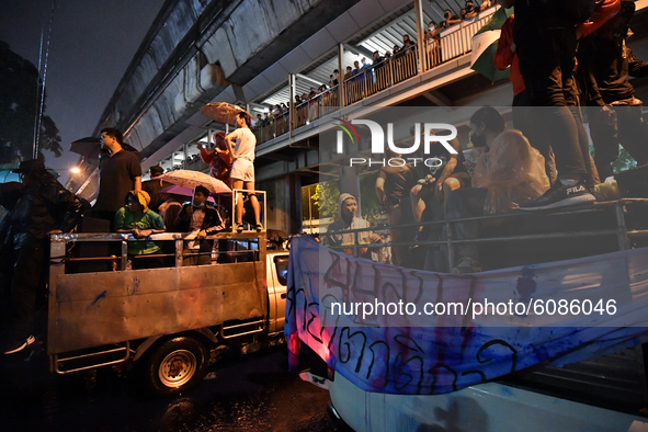 Pro-democracy protesters gather outside the Royal Thai Police Headquarters to protest the earlier arrest of protesters rally at Democracy Mo...