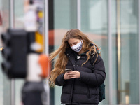 Daily life in Eindhoven city in the Netherlands with people wearing facemask as they are outside walking or on the bicycle as a protective m...