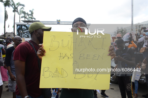 Youths of ENDSARS protesters display their placards in a crowd in support of the ongoing protest against the harassment, killings and brutal...
