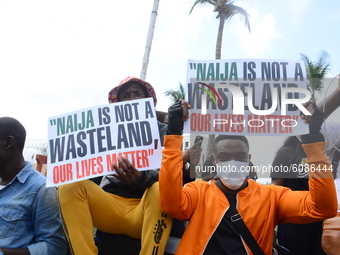 Youths of ENDSARS protesters display their placards in a crowd in support of the ongoing protest against the harassment, killings and brutal...