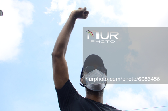A END SARS protester hold his fists in the air showing his support of the ongoing protest against the harassment, killings and brutality of...