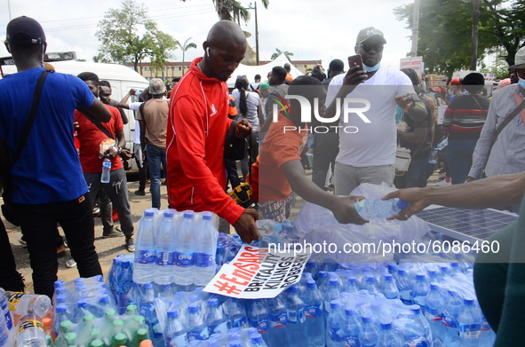 Volunteers share foods and drinks during the END SARS protest in support of the ongoing protest against the harassment, killings and brutali...