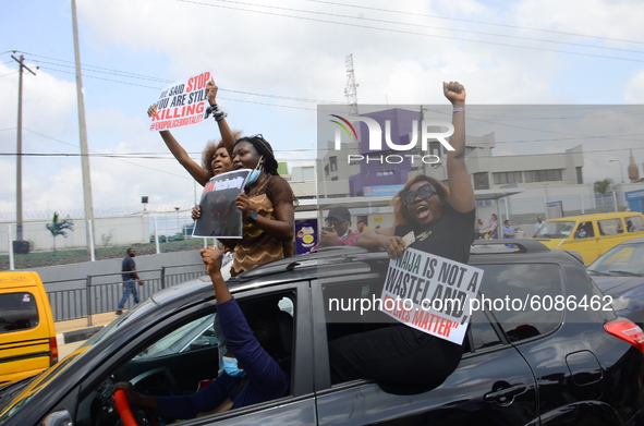 Youths of ENDSARS protesters display their placards in a car in support of the ongoing protest against the harassment, killings and brutalit...