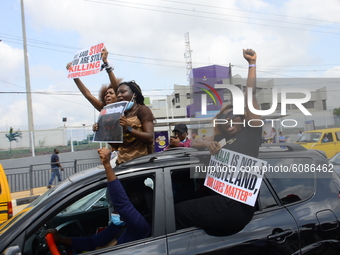 Youths of ENDSARS protesters display their placards in a car in support of the ongoing protest against the harassment, killings and brutalit...