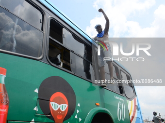 Youth of ENDSARS protesters hang on to a bus raising his fists in the air in support of the ongoing protest against the harassment, killings...