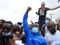 Youths of ENDSARS protesters raise their fists in the air in support of the ongoing protest against the harassment, killings and brutality o...