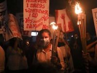 Female activists and students take part in a torch procession demanding women's safety and justice for rape victims, amid the coronavirus di...