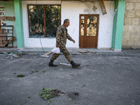 A soldier walks in a Stepanakert street shelled by cluster ammunition rocket launched by Azerbaijan army over Nagorno Karabakh capital on Oc...