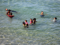 Palestinian children enjoy the sea during hot weather, amid the coronavirus disease (COVID-19) outbreak in Gaza City October 14, 2020.
 (