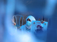 A woman wearing a protective face mask holds a picture of Maher Al-Akhras, 49, a Palestinian jailed by Israel, who has been on hunger strike...