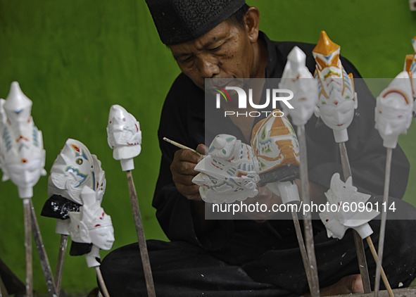 Wayang Golek craftsman Entang Sutisna (73), produces wayang golek made of lame wood (Alstonia scholaris) at Media Art, in Bogor City, West J...