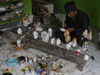 A Wayang Golek craftsman Entang Sutisna (73), produces wayang golek made of lame wood (Alstonia scholaris) at Media Art, in Bogor City, West...