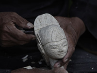 A Sculptor Entang Sutisna (73), produces Wayang Golek or golek puppet at Media Art, in Bogor City, West Java, Indonesia, on October 15, 2020...