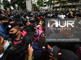 Pro-democracy protesters combat police officers during a rally at Ratchaprasong interjection central of Bangkok near Royal Thai Police Headq...