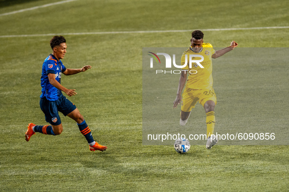 Columbus midfielder, Fatai Alashe, kicks the ball during an MLS soccer match between FC Cincinnati and the Columbus Crew at Nippert Stadium,...