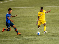 Columbus midfielder, Fatai Alashe, kicks the ball during an MLS soccer match between FC Cincinnati and the Columbus Crew at Nippert Stadium,...