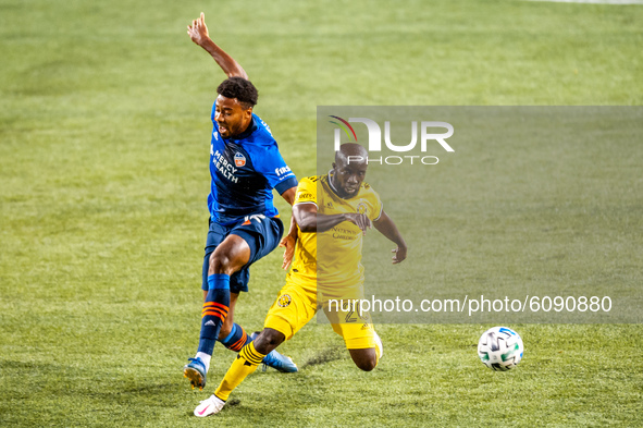 Columbus midfielder, Emmanuel Boateng, and FC Cincinnati defender, Saad Abdul-Salaam, compete for the ball during an MLS soccer match betwee...