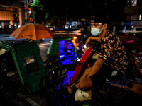 A driver wearing a face mask rests on his tricycle while waiting for passengers in Manila, Philippines on October 15, 2020.(