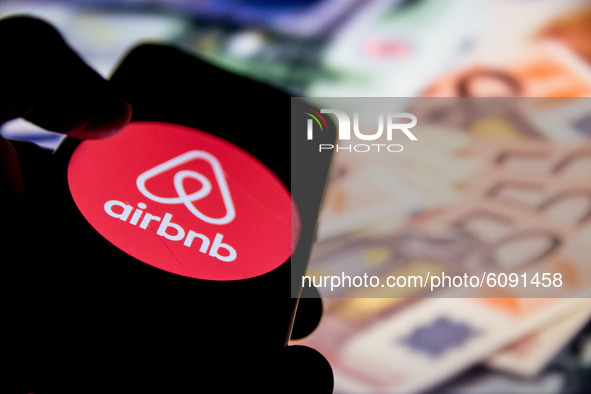 In this photo illustration a Airbnb logo is displayed on a smartphone screen and Euro bills as background on a computer screen in Athens, Gr...
