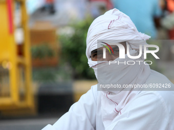People cover their face with masks to curb the spread of coronavirus pandemic at Connaught Place in New Delhi, India on October 15, 2020. In...