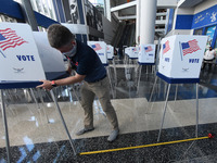 Workers set up voting booths six feet apart for social distancing at an early voting site established by the City of Orlando and the Orlando...