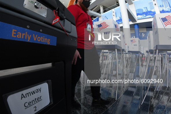 A tabulation machine and voting booths are seen during the set up of an early voting site established by the City of Orlando and the Orlando...