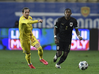 David Alaba of Austria in action against Ciprian Deac of Romania during match against Romania of UEFA Nations League football match in Ploie...