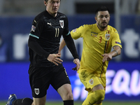 Michael Gregoritsch of Austria in action against Alin Tosca of Romania of Romania of UEFA Nations League football match in Ploiesti city Oct...