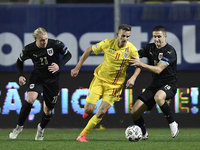 Nicusor Bancu of Romania in action against Reinhold Ranftl and Xaver Schlager of Austria  during the UEFA Nations League match between Roman...
