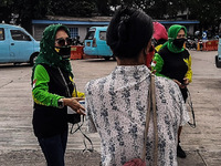Volunteers distribute lunch for transport drivers at the Kampung Melayu terminal, Jakarta, Indonesia, on October, 16, 2020. The food is dist...