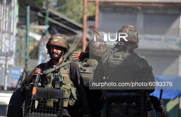  Indian soldiers are seen atop of a vehicle during an anti-militancy operation launched by Indian forces in central Kashmir's Chadoora on Oc...