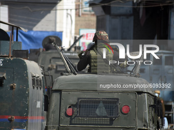  An Indian army man stands atop of a vehicle during an anti-militancy operation launched by Indian forces in central Kashmir's Chadoora on O...