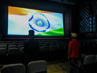 People standing for the national anthem of India before the start of Movie at a theatre in Kolkata, India, on October 16, 2020. Cinema halls...