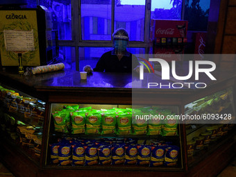 A cinema hall staff wearing protective gear inside a beverage stall at a movie hall in Kolkata, India, on October 16, 2020. Cinema halls are...