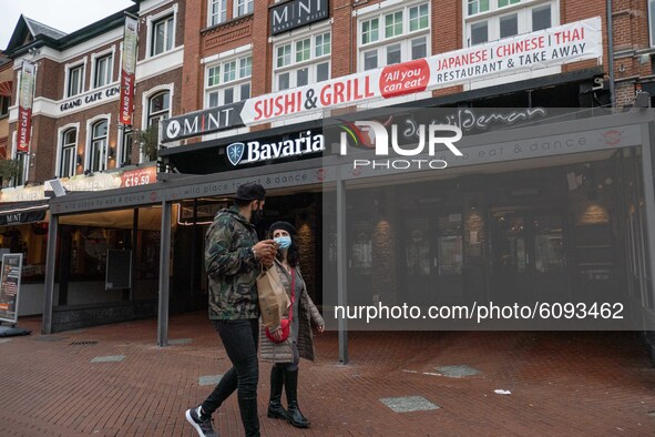 People of Eindhoven passing infront of closed cafes and bars during the partial lockdown and daily life in Eindhoven city in the Netherlands...