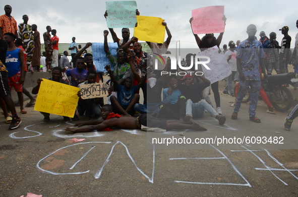 The Youths of End Sars Protesters gather in front of graffiti with description (END SARS) to barricade the Lagos - Ibadan expressway, the ol...
