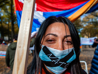 An Armenian woman with the word NATO wrote on  her mouth mask is looking at the camera, during the Armenian community protest against Israel...