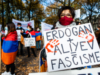 An Armenian woman is holding a placard against Erdogan, during the Armenian community protest against Israel's arms deliveries to Azerbaijan...