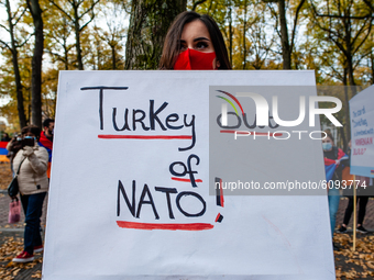 An Armenian woman is holding a big placard against Turkey, during the Armenian community protest against Israel's arms deliveries to Azerbai...