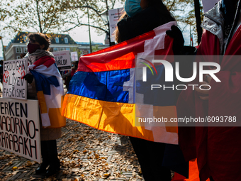 A woman is holding an Armenian flag, during the Armenian community protest against Israel's arms deliveries to Azerbaijan, in The Hague, on...