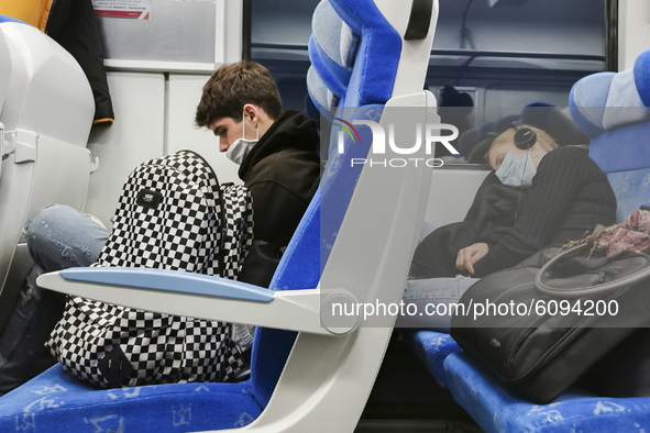 People wear face masks while travelling on train during coronavirus pandemic. Krakow, Poland on October 14th, 2020. Due to the increasing sp...